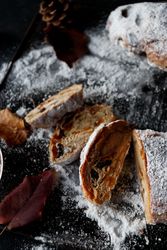 Pieces of Stollen near sieve and autumn leaves