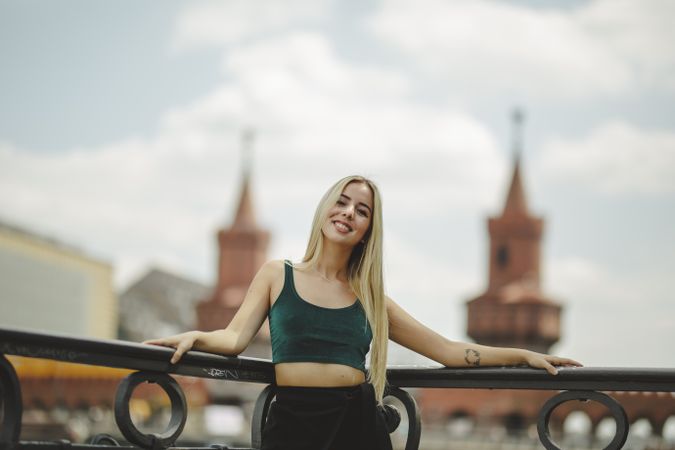Blonde woman leaning on railing