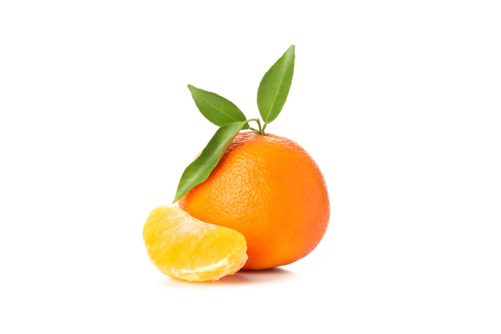 Ripe mandarin with leaves isolated on light background
