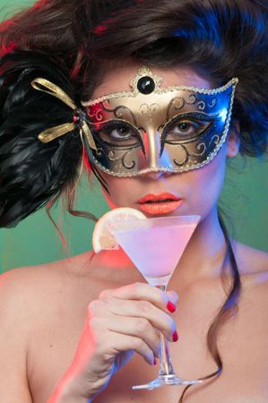 Woman in mask holding glass of drink