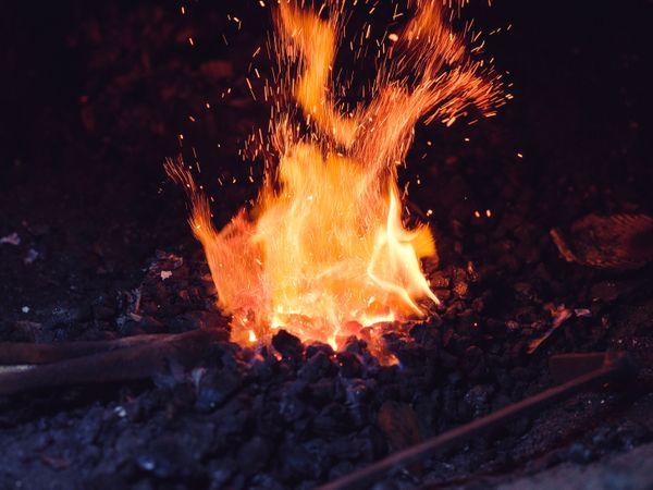 Metal being heated in furnace in workshop
