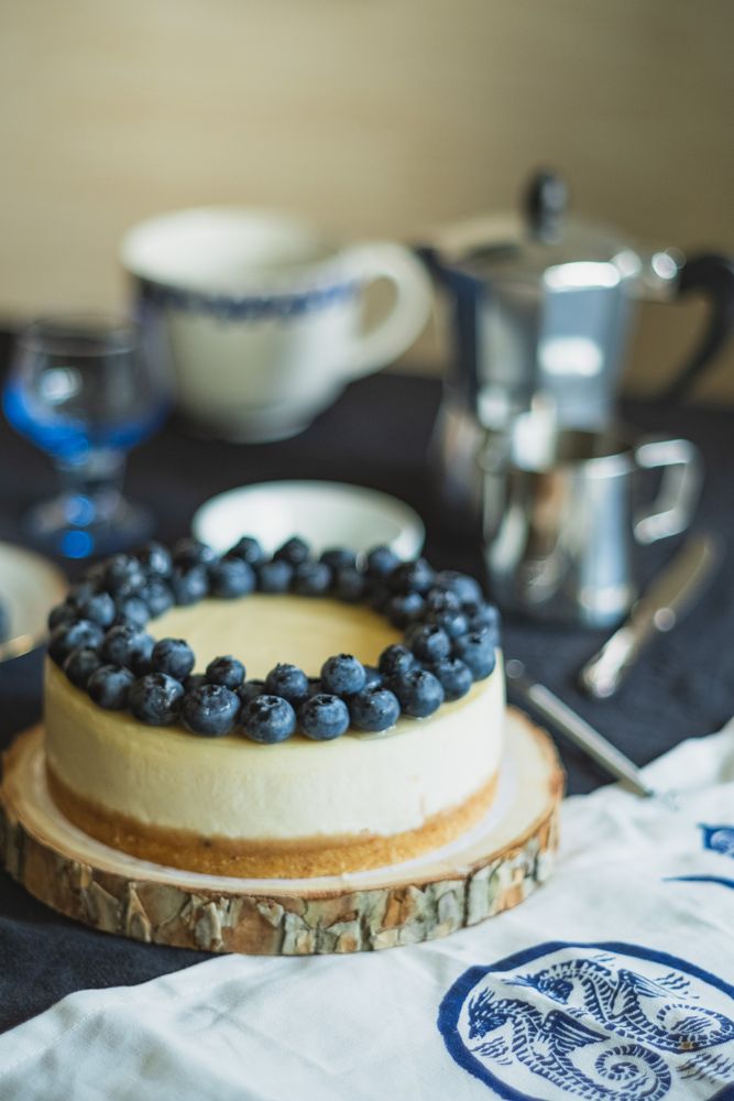 Sweet fruit cheesecake dessert on wood serving cake stand