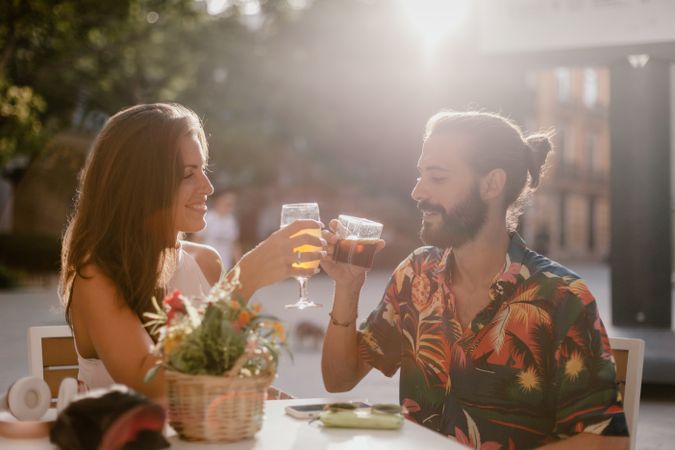 Loving couple clinking glasses on cafe terrace
