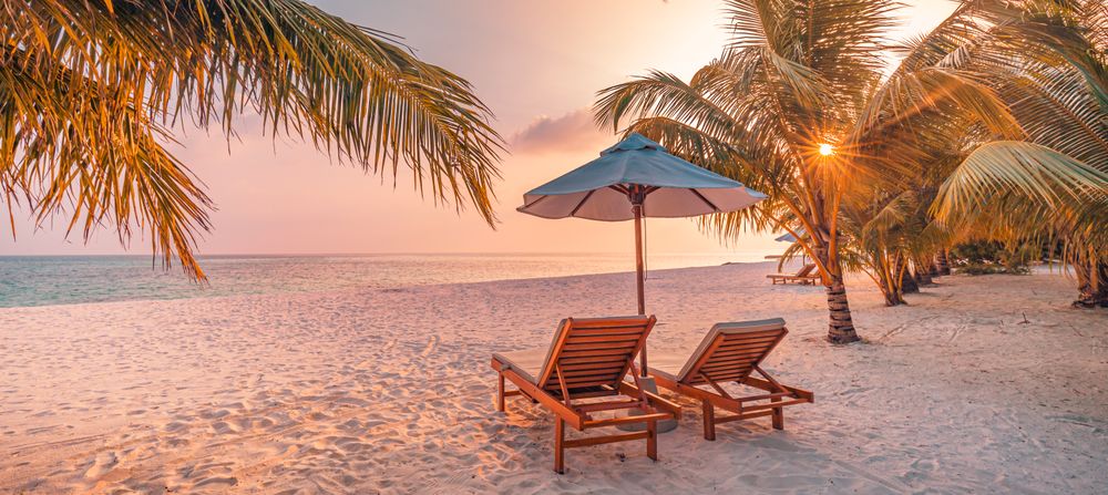 Tranquil spot on the beach to relax with sunflare, wide