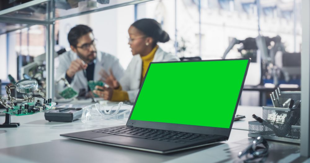 Laptop Computer with Green Screen Mock Up Display Standing on a Table in a Science Class Laboratory.