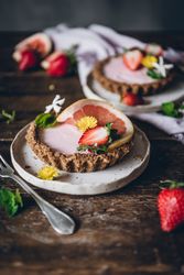 Strawberry and citrus cake served on wooden table