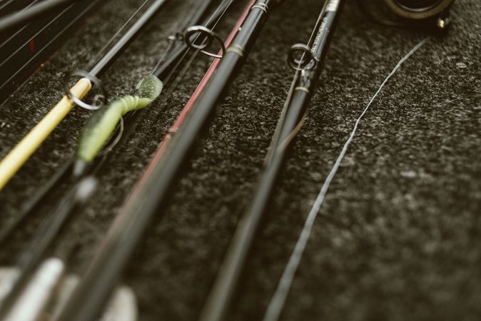 Fishing rods on pebbles on cloudy day