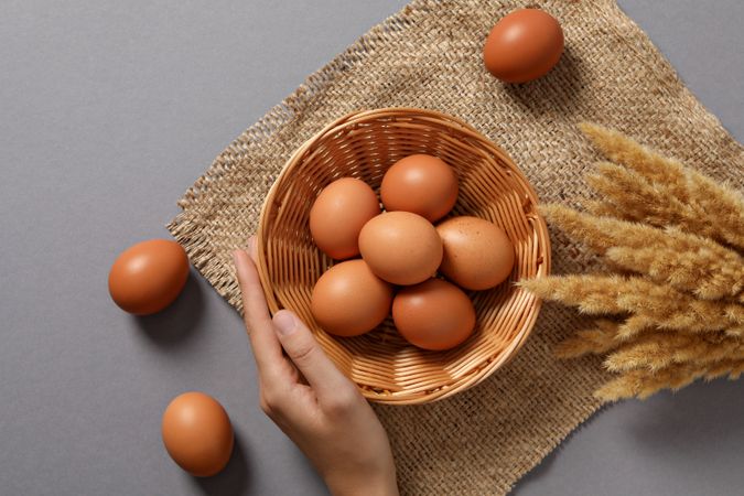 Eggs in a wicker basket, on a gray background.