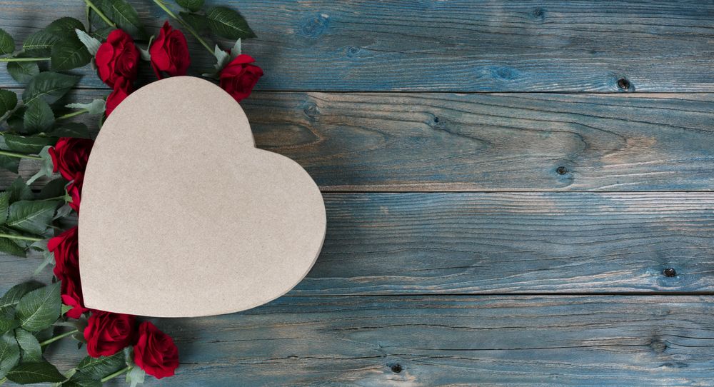 Valentine’s day with gift box and roses on faded blue wood