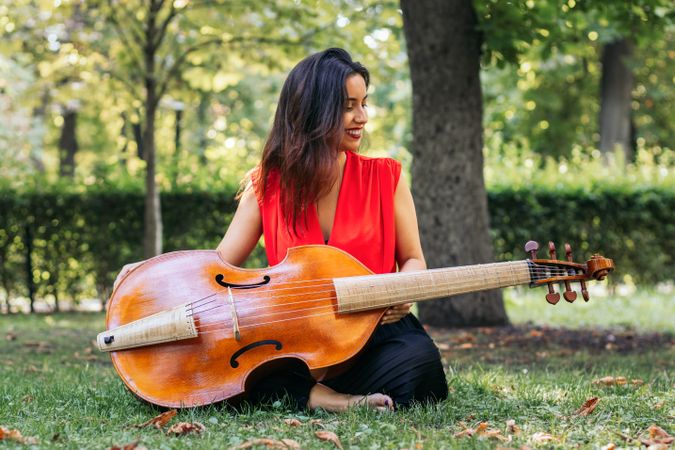 Woman with cello in a park