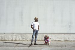Man and dog in American flag on street
