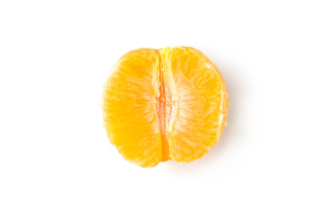 Half of ripe mandarin isolated on light background