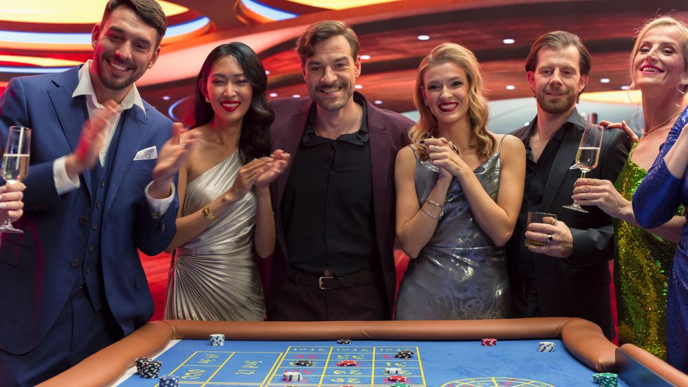 Casino Enthusiasts Making Calculated Bets at a Roulette Table.