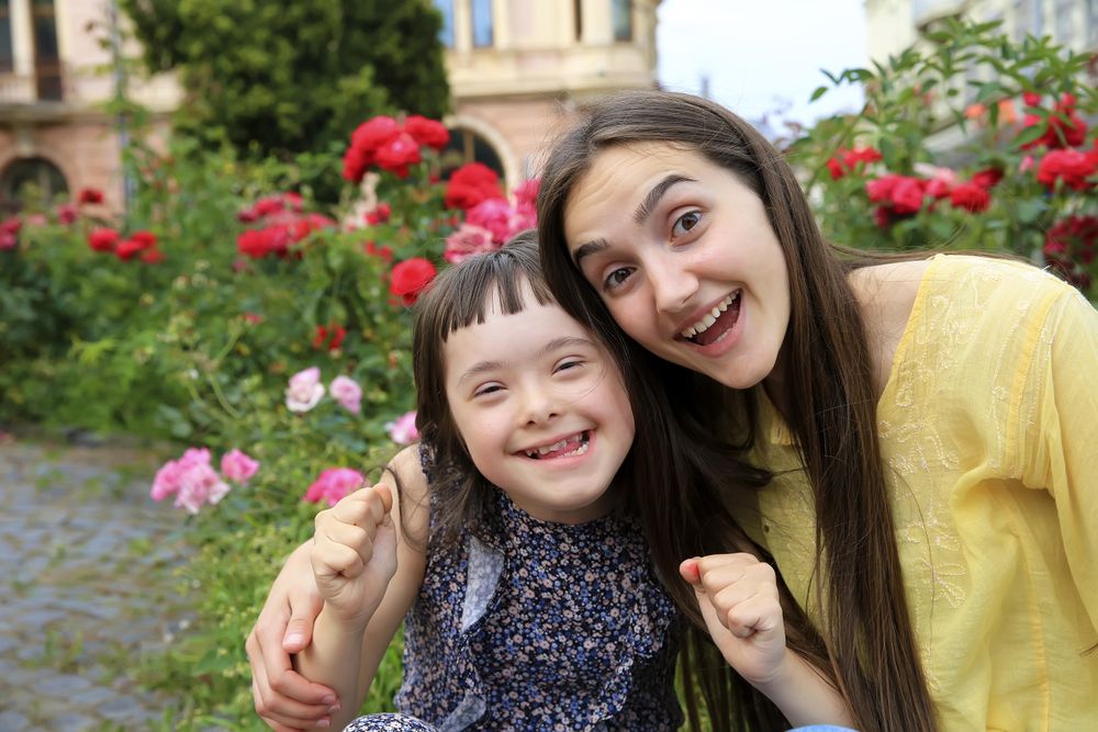 Excited sisters hugging together