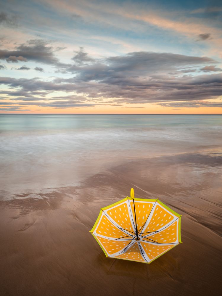 Umbrella on beach near sea