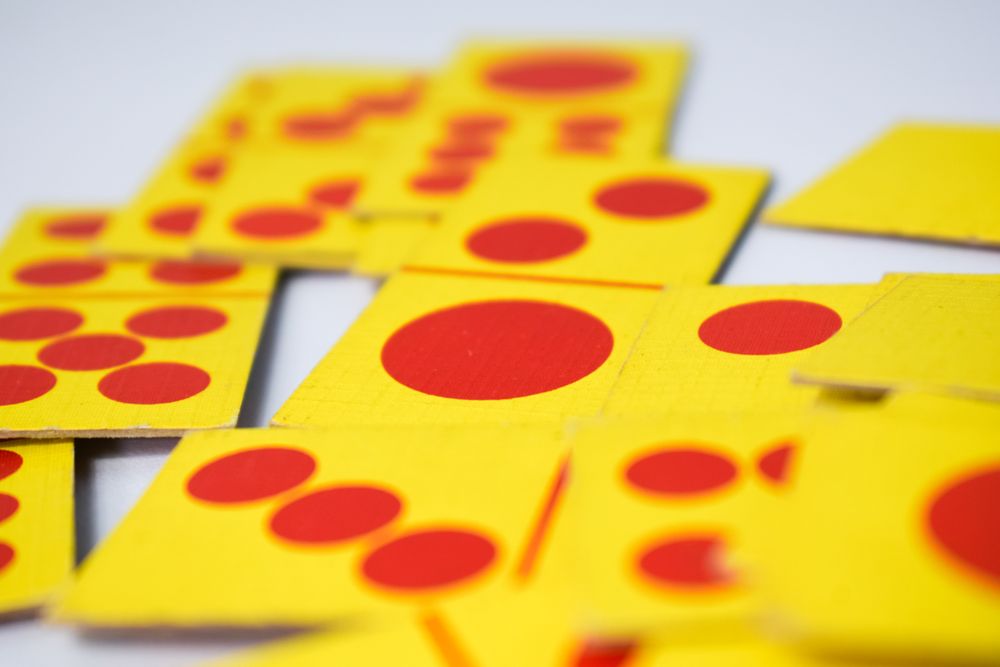 Close up of red and yellow domino playing cards with selective focus