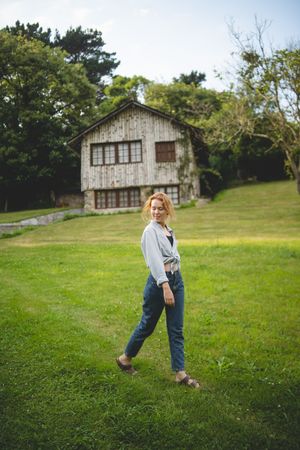 Content female walking on grass in countryside