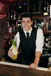 Barman working preparing drink in a glass