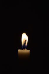 Side view of candle flame light in the dark