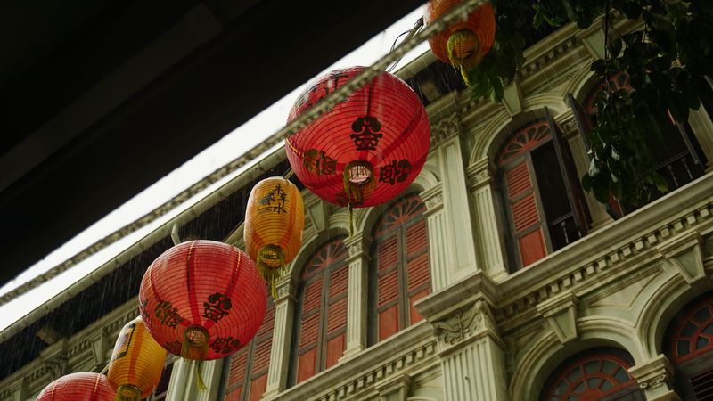 Red and yellow paper lantern decoration beside concrete building