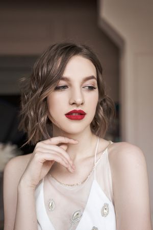 young confident woman with red lips looking away