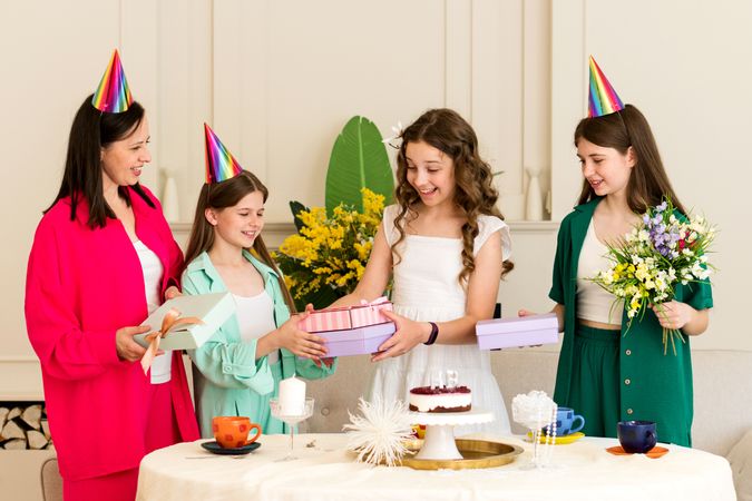 Girl in white dress is given gifts by family