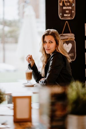 Woman drinking coffee from a glass