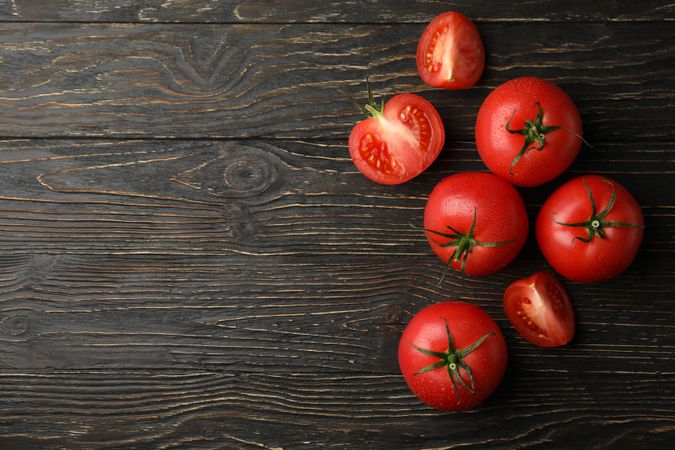 Fresh ripe tomatoes on wooden background, top view