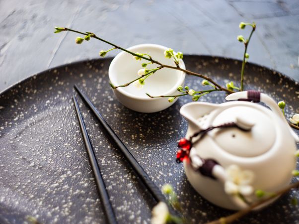 Asian style tea set with chop sticks and branch