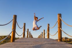 Woman posing in air on footbridge