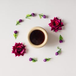 Flowers arranged in circle with coffee mug