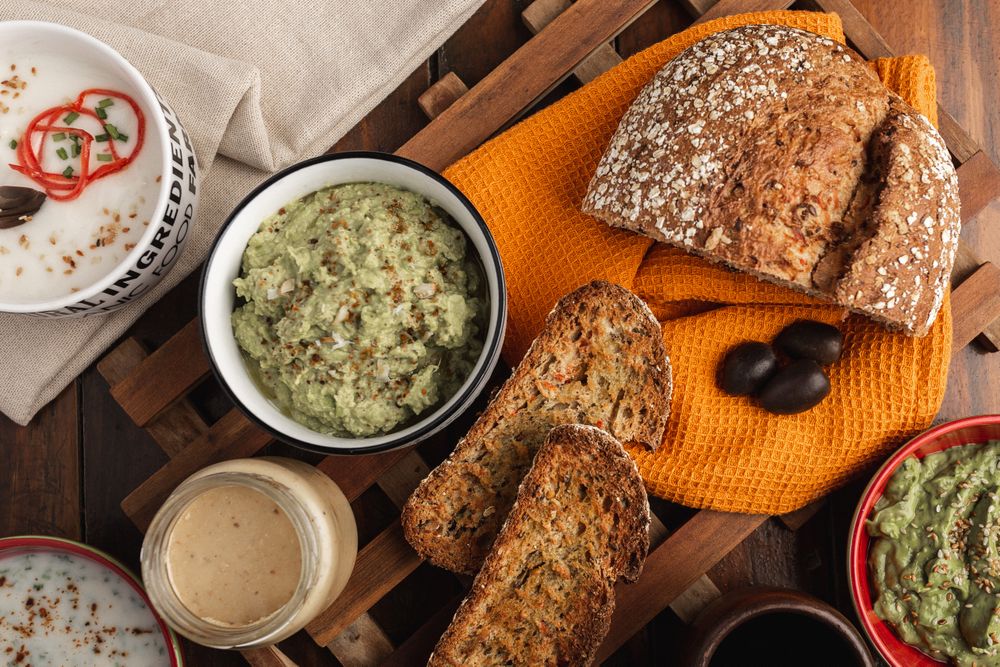 Tasty sauces decorated with sesame seeds and lush bread