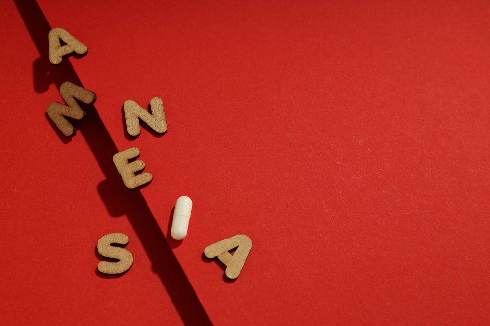 Dark line with scattered letters saying “Amnesia” with copy space