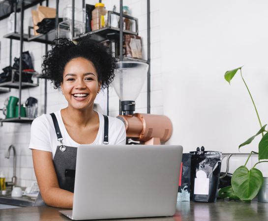 Smiling barista at laptop