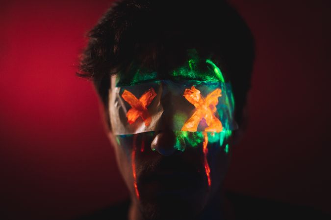 Male with covered eyes and neon face