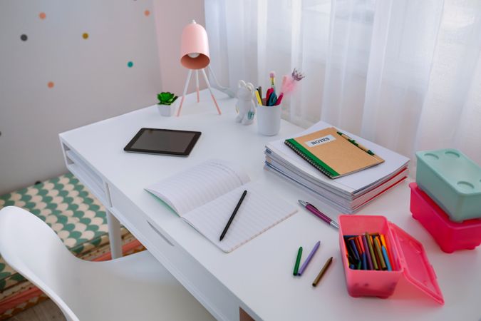 Desk in girl's bedroom decorated in pastel colors