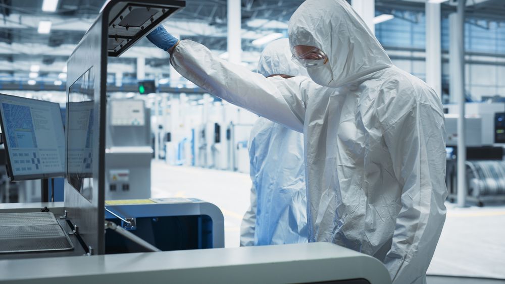 Scientists in hazmat suits doing lab work