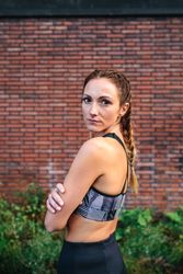 Sporty woman with boxer braids posing