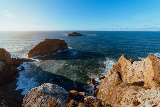 High cliff near water in sunny day