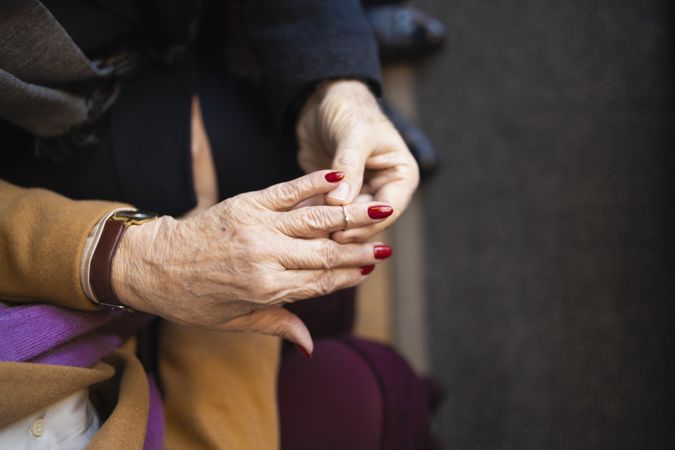 Mature man slipping on ring onto his new fiancé