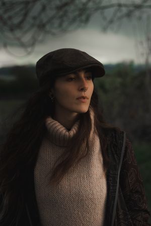Young woman in warm clothes in forest