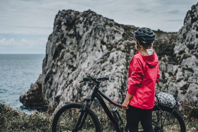 Anonymous female bicyclist on rocks