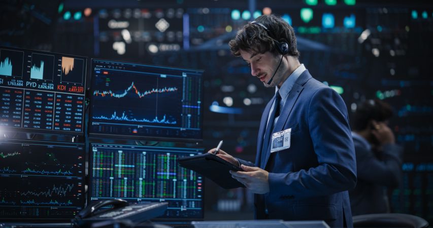 Professional Using a Tablet Computer, Monitoring Financial Markets, Communicating with Corporate Business Partners
