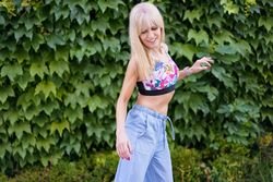 Dancer in casual summer clothes dancing next to garden