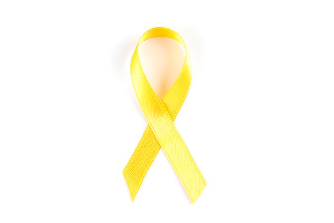 Yellow awareness ribbon isolated on blank background