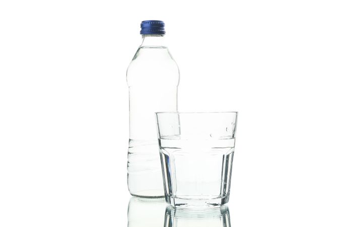 Plastic water bottle with glass of water