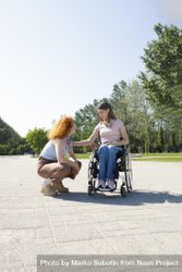 Woman with a disability chatting to her friend outside 5ze2j0