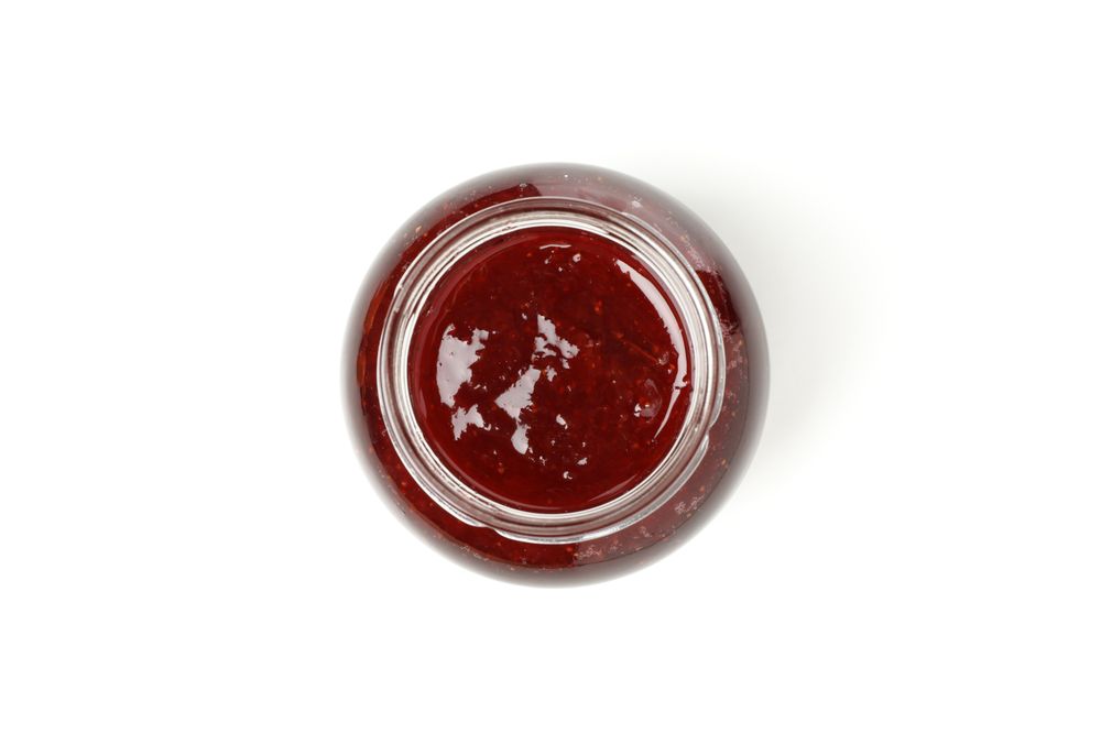Delicious strawberry jam isolated on plain background