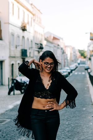 Joyful trendy female in old town street