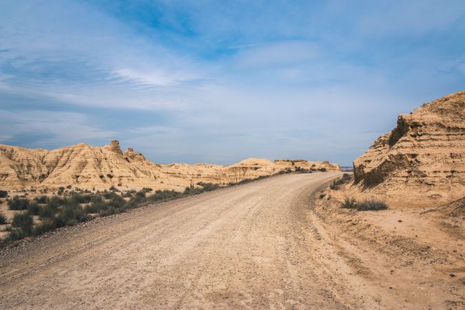Empty road in desert hills on background of blue sky